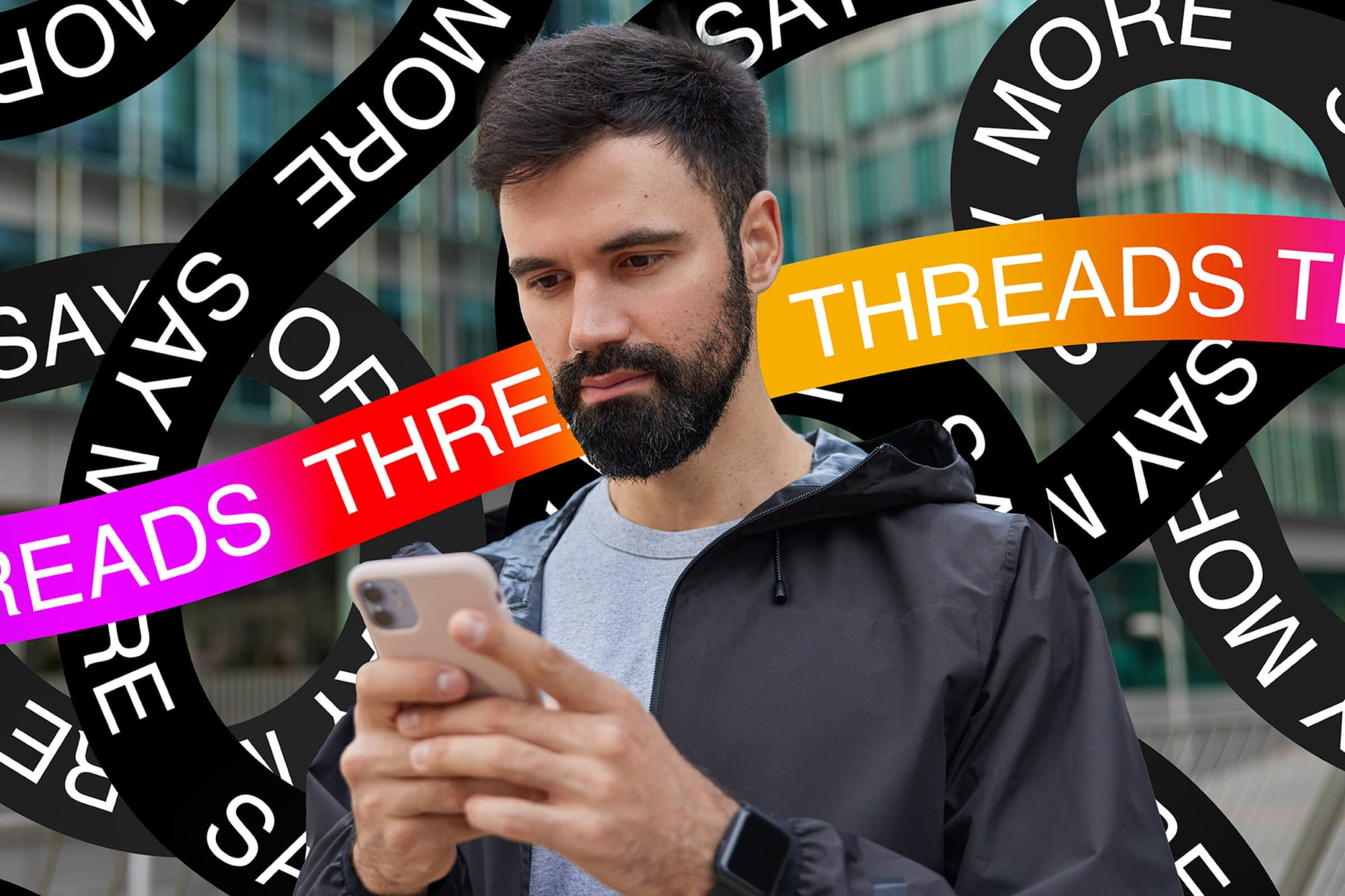 A man using his phone is surrounded by bold "Threads" and "Say More" text ribbons in vibrant colors, set against an urban background.