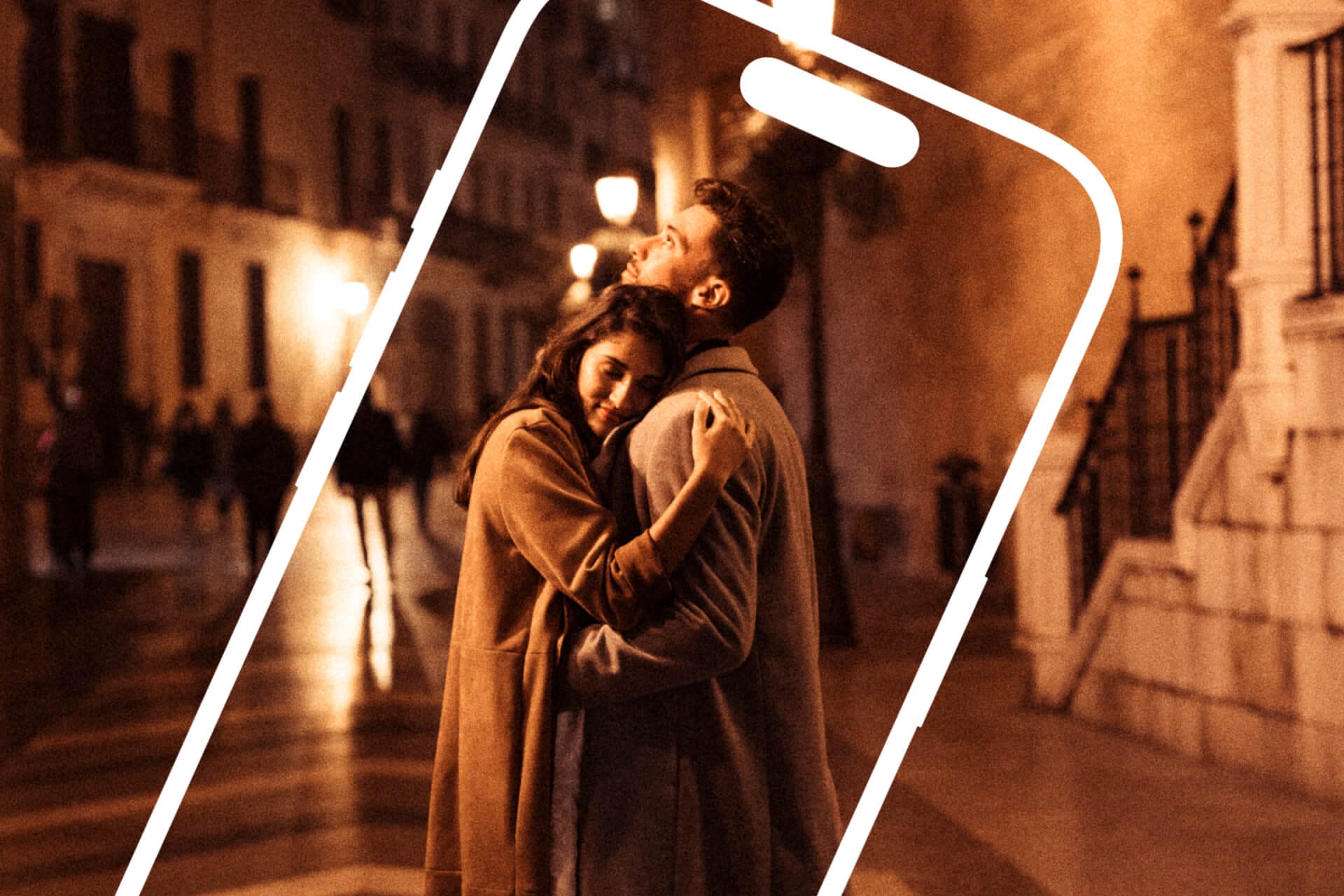 A couple hugging on a city street at night